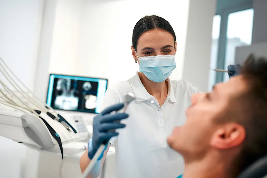 Dentist treating a patient in a dental office — representing dental practices using SEO, website development, and local visibility to reach more ideal patients.
