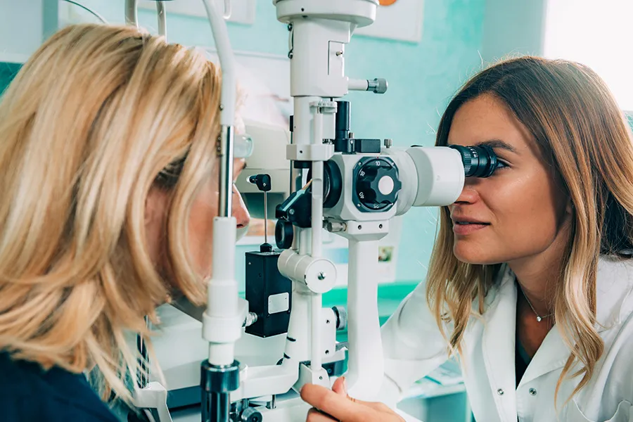 Optometrist examining a patient’s eyes — representing SEO for optometry practices seeking visibility for eye care services, symptoms, treatments, and specialty care.